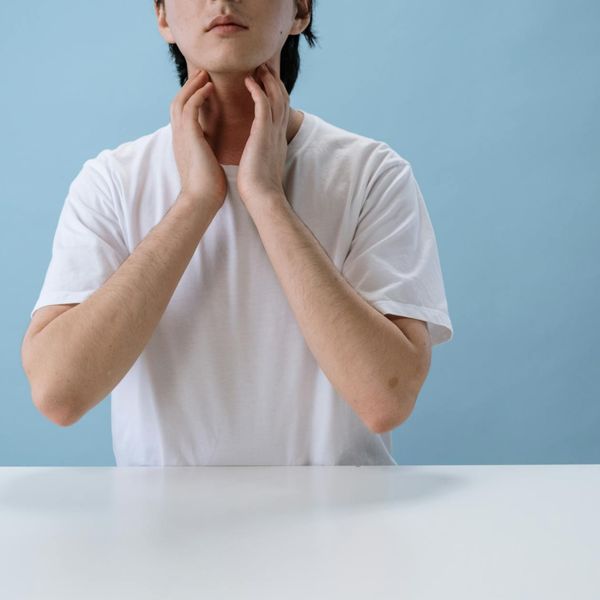 Person in a calm, balanced pose against a serene background.