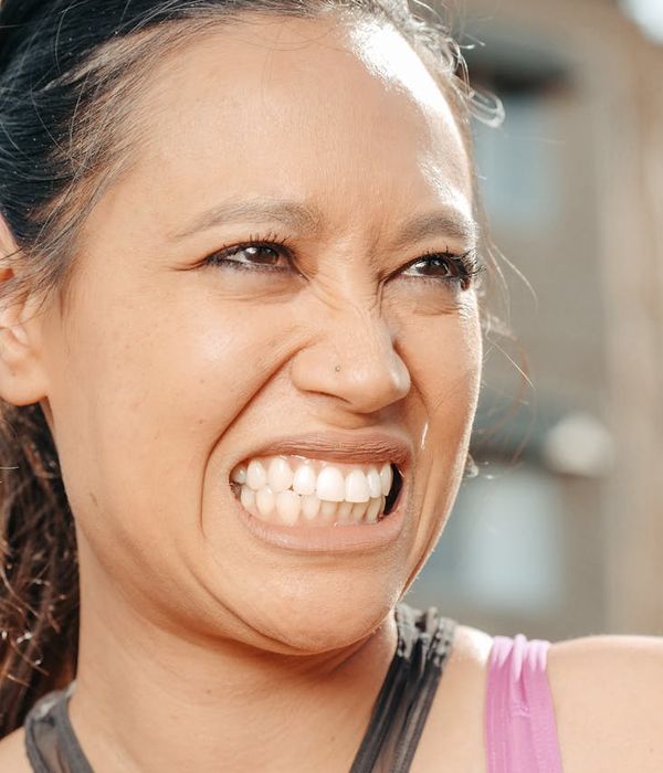 Woman feeling energetic and positive in a bright room.